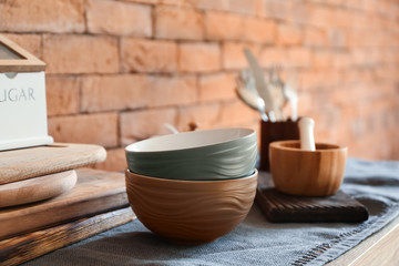 Set of clean dishware on wooden table