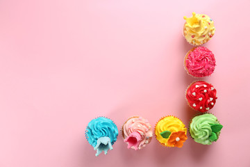 Fototapeta na wymiar Delicious cupcakes on color background