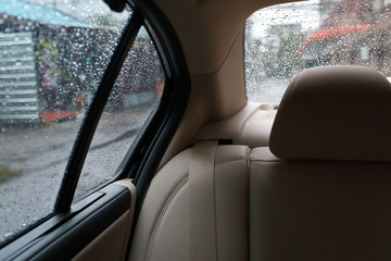 Fototapeta na wymiar back seat inside vehicle car with rain drop on window
