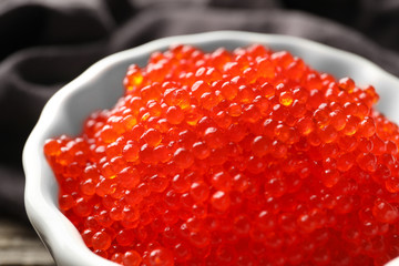 Bowl with delicious red caviar, closeup