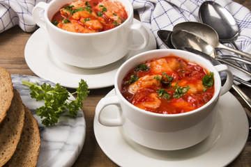 sea food mix soup in a white bowl
