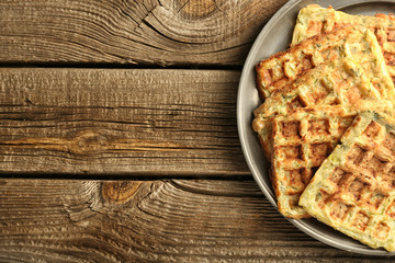 Metal tray with tasty squash waffles on wooden table
