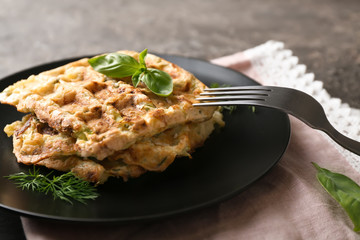 Plate with tasty squash waffles on grey table