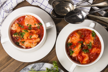 sea food mix soup in a white bowl