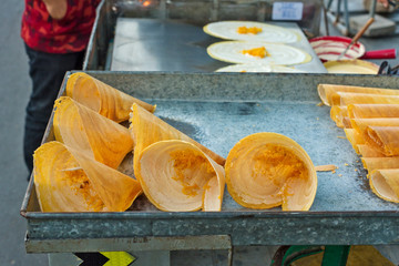 Phnom Penh / Cambodia - pancakes with grated carrot and coconut milk, sold on the sidewalk