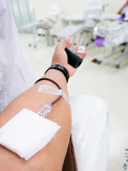 donate blood with a bouncy holding in hand receiving blood in hospital. Healthcare and charity Concept.