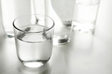 Glass of fresh water on grey table