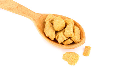 Brown Unrefined Single Evaporated Demerara Cane Sugar Cube Chunk Pieces in Wooden Spoon, Isolated on White Background.