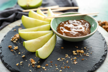 Plate with sauce and apple slices on slate plate