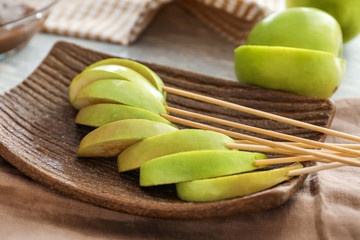 Sticks with apple wedges on plate