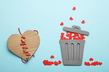 Discarded heart and relationship in couple. Red broken hearts in trash can.