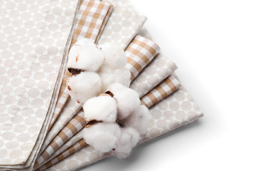 Clean kitchen towels with cotton flowers on white background