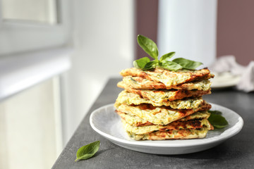 Plate with tasty squash waffles on grey table