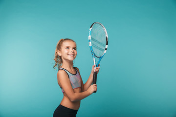 Cheerful young sports girl playing tennis