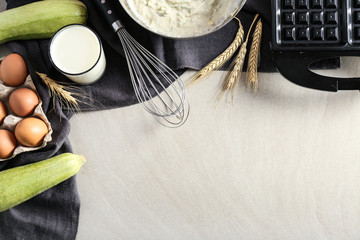 Ingredients and modern maker for preparing of squash waffles on light table