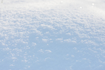 Obraz premium White blue snow texture background with bokeh. Close up of fresh clean snow with blue shadows. Selective focus