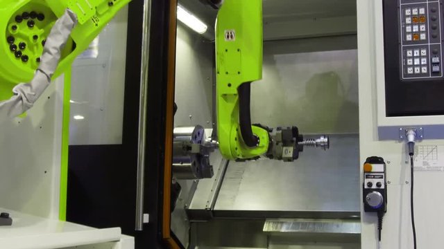 The robot arm sets the parts for machining in the CNC milling center