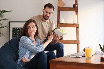 Woman refusing to take bouquet from her boyfriend