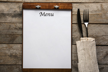 Blank menu with cutlery on wooden table - obrazy, fototapety, plakaty