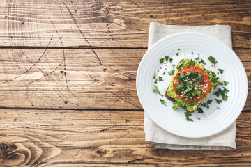 Avocado toast. Healthy toast with avocado mash and tomatoes on a plate.