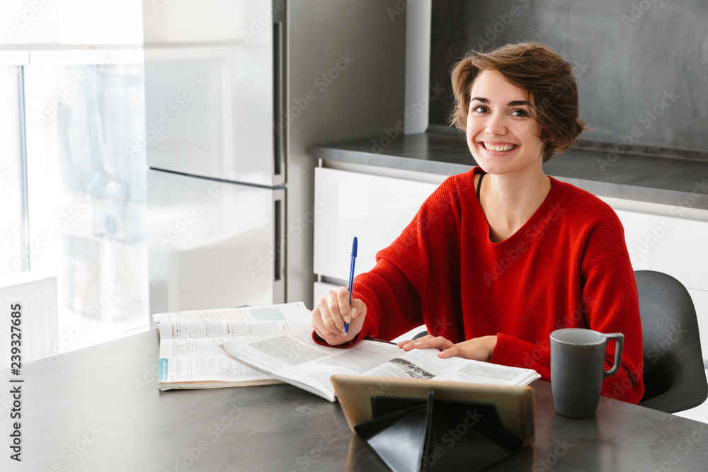 Wall mural smiling pretty young woman studying