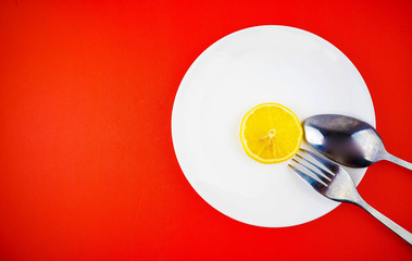 Lemon slices in white plate with spoon