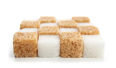Different cubes of sugar on white background