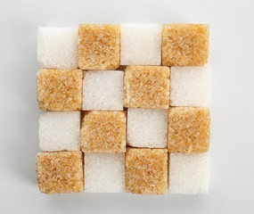 Different cubes of sugar on white background