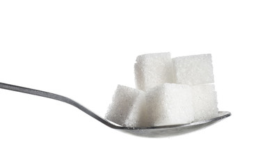 Spoon with sugar cubes on white background