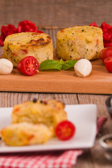 Potato gratins with mozzarella and tomatoes.