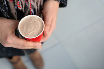 Woman with paper cup of tasty aromatic coffee, closeup