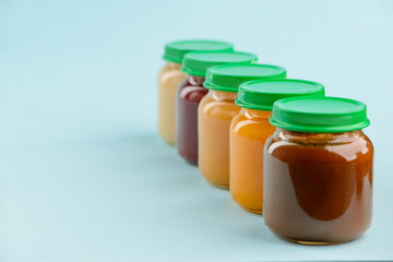 Packaged baby food on blue.