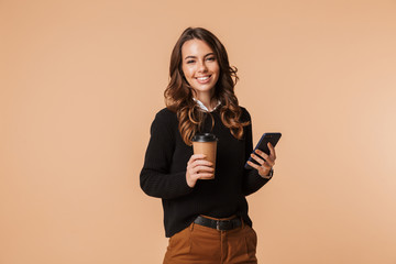 Smiling young woman wearing sweater standing