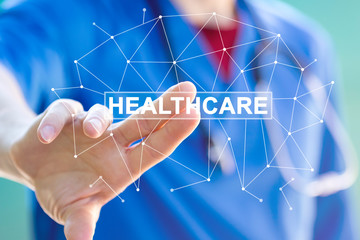 Doctor pushing button healthcare text on virtual panel.
