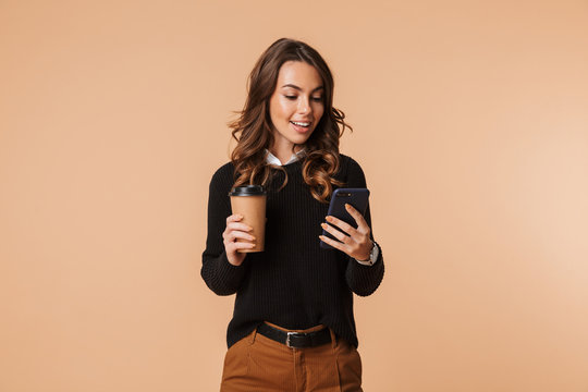 Smiling young woman wearing sweater standing