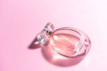Bottle of perfume on color background