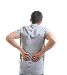 Young man suffering from back pain on white background