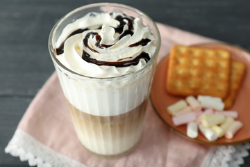 Glass of tasty aromatic latte on table