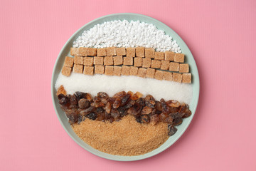 Plate with different kinds of sugar and sweetener tablets on color background