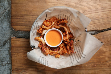 Tasty fried squid with sauce on table © Pixel-Shot