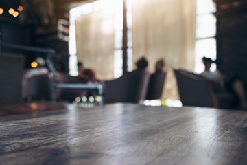 Wooden table with blurred people in cafe