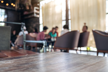 Wooden table with blurred people in cafe