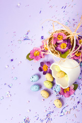 Easter decor in pastel colors. Easter eggs, candy, sweets, flowers and eggshells.