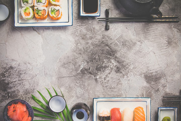 Flat-lay of sushi set on grey concrete background, horizontal composition © Natalia Klenova