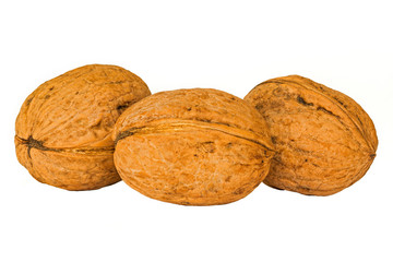 three walnuts on a white background without shadows. Native fruits of the Greek nuts and grains on a white background