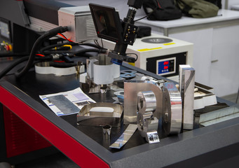 3D Alphabet letter logo from laser welding machine. Industrial metalwork manufacturing.