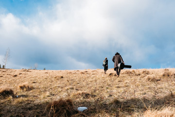 Couple, having risen on the road on the autumn mountain against the cloudy sky