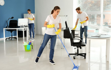 Fototapeta na wymiar Team of janitors cleaning office