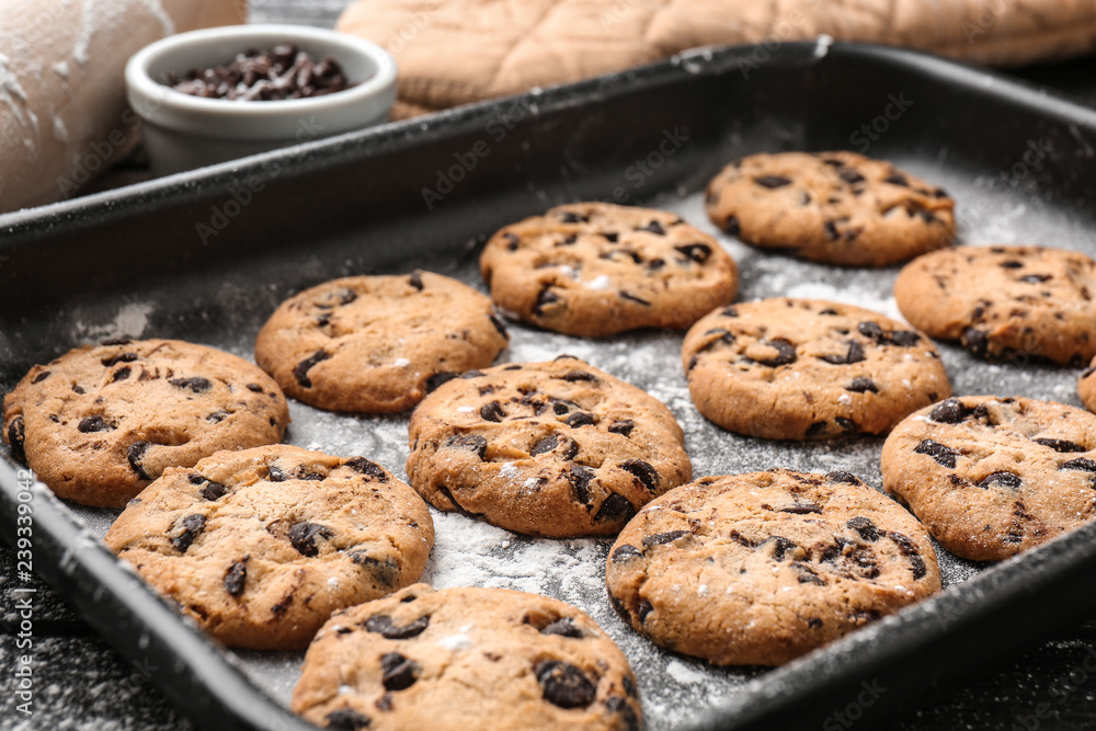 Wall mural tasty cookies with chocolate chips on baking tray - Wall murals