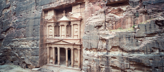 ancient treasury in Petra Jordan seen from the Siq. view from the top. main attraction of the lost city of Petra in Jordan. The temple is entirely carved into the rock. Ancient architecture. - obrazy, fototapety, plakaty